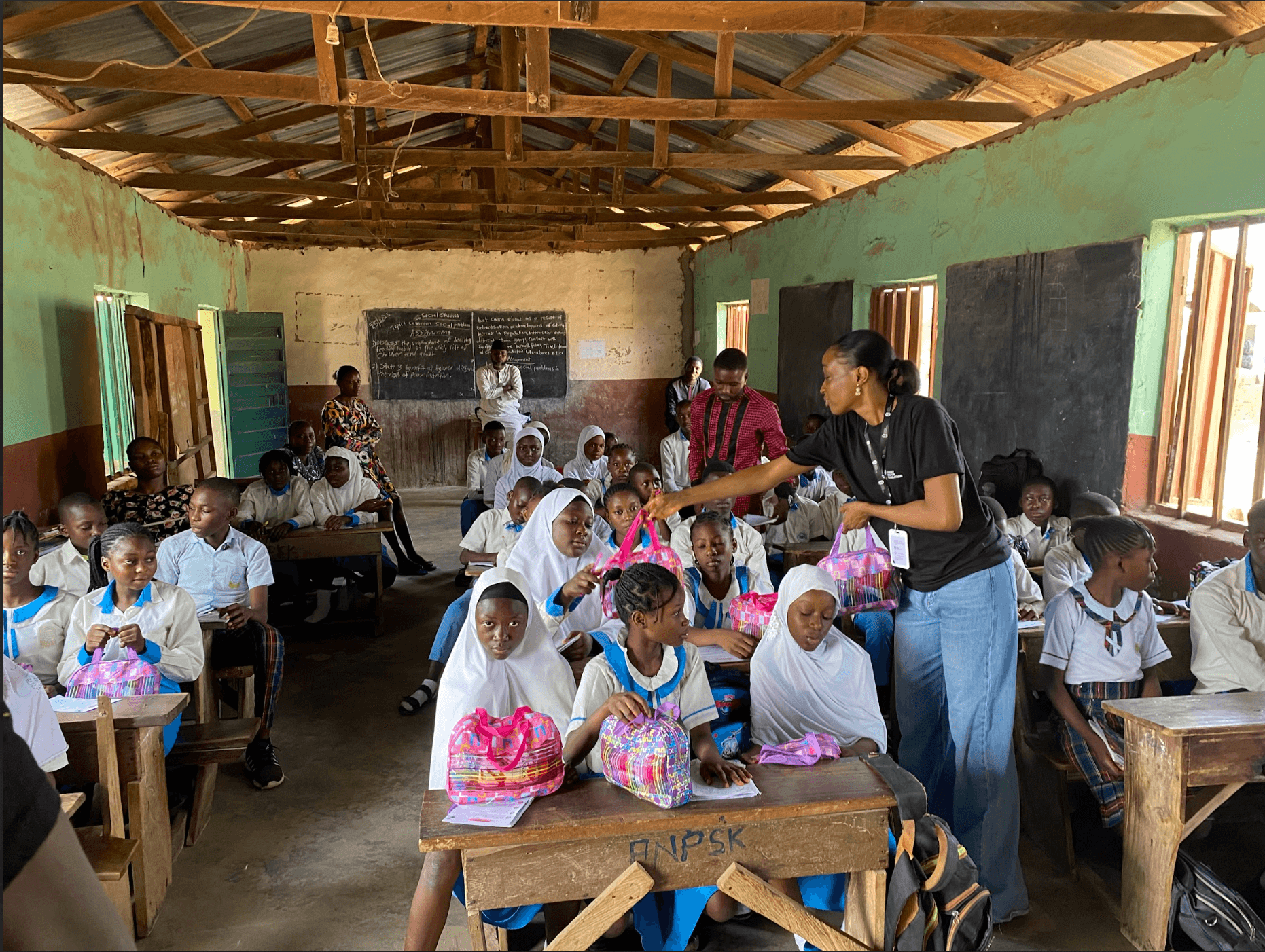CNF volunteer distributing hygiene kits to students during Project WASH